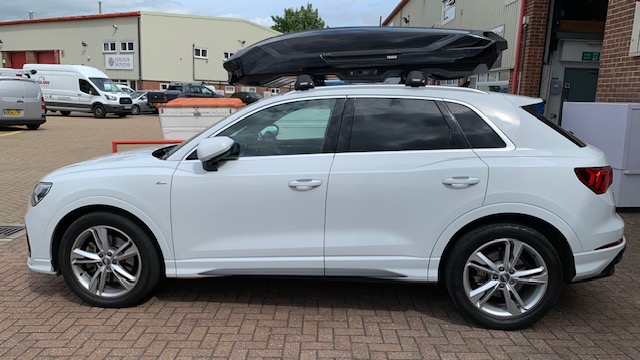 Audi Q3 with Thule Motion 3 XL Glossy Black roof box and Thule WingBar Edge Black roof bars
